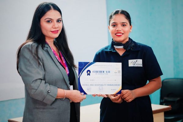 Two women holding a certificate