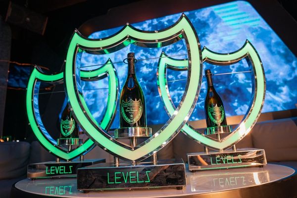 a table with three bottles of champagne on top of it