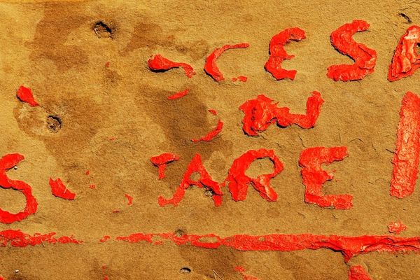 Red letters on textured surface