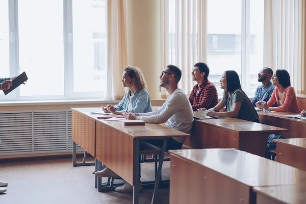 Professor lecturing to students in a classroom.