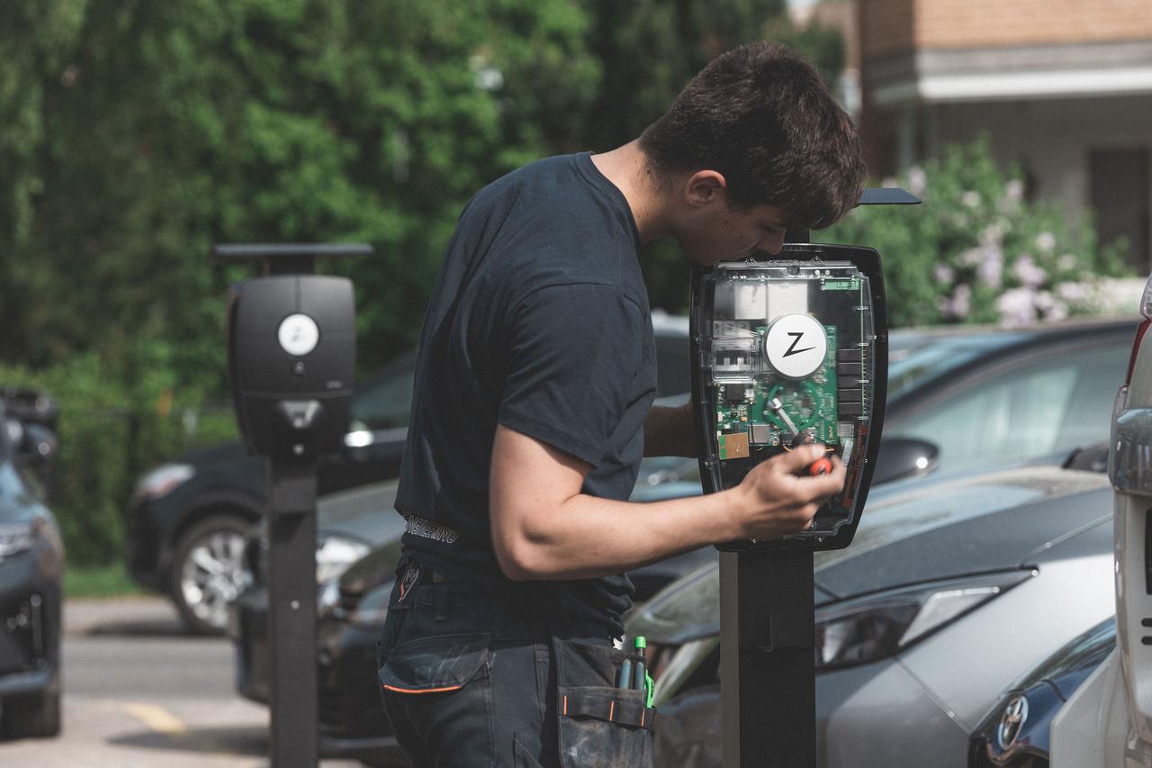 photo of a man installing an ev-charger
