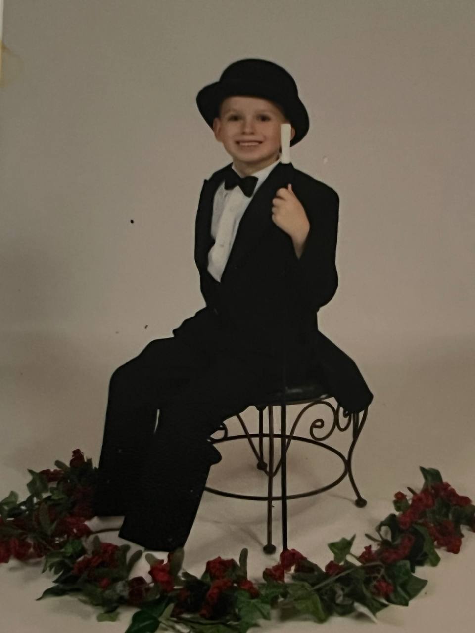 Tiny tuxedo, big top hat — early performer days.