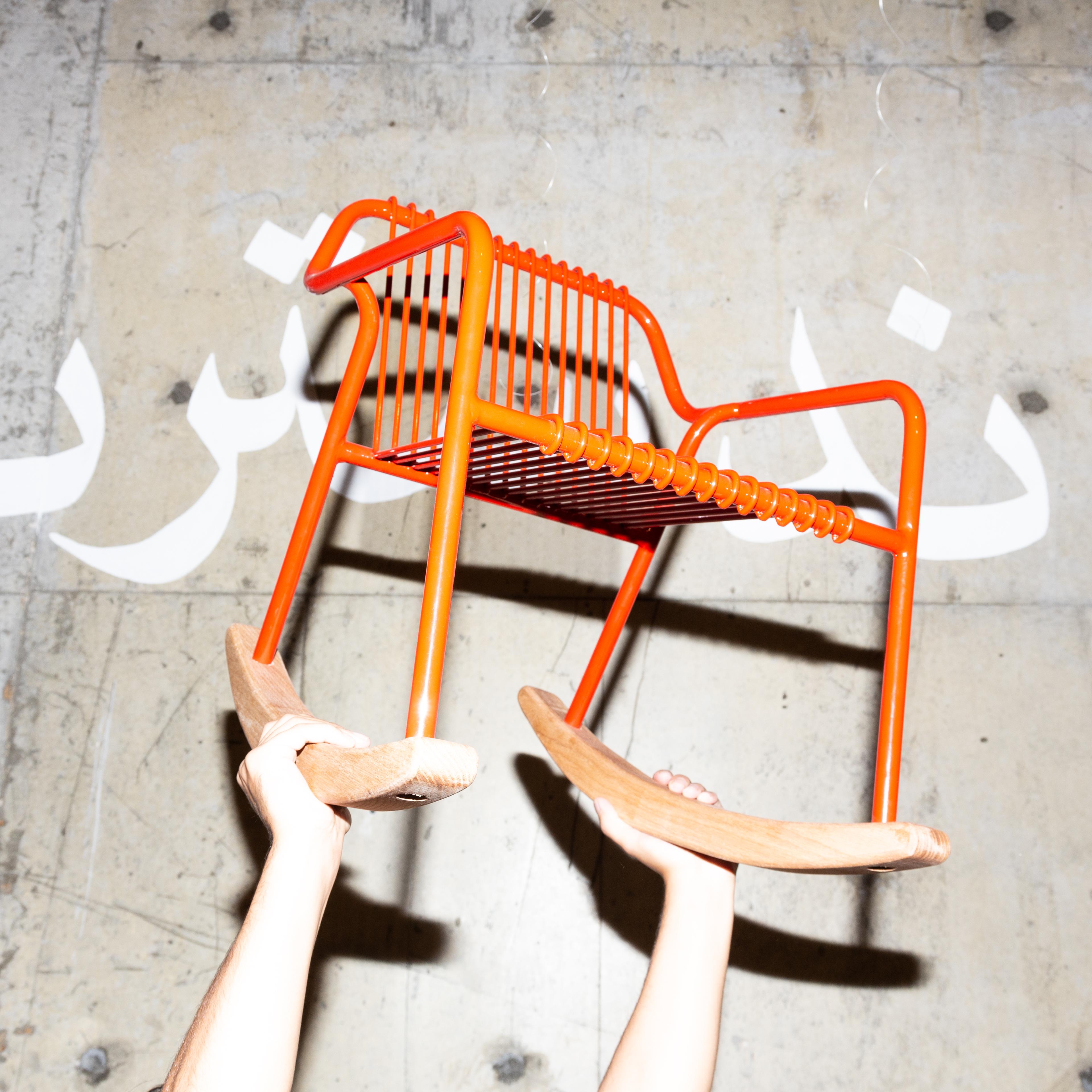 Photo of orange chair being held up in the air