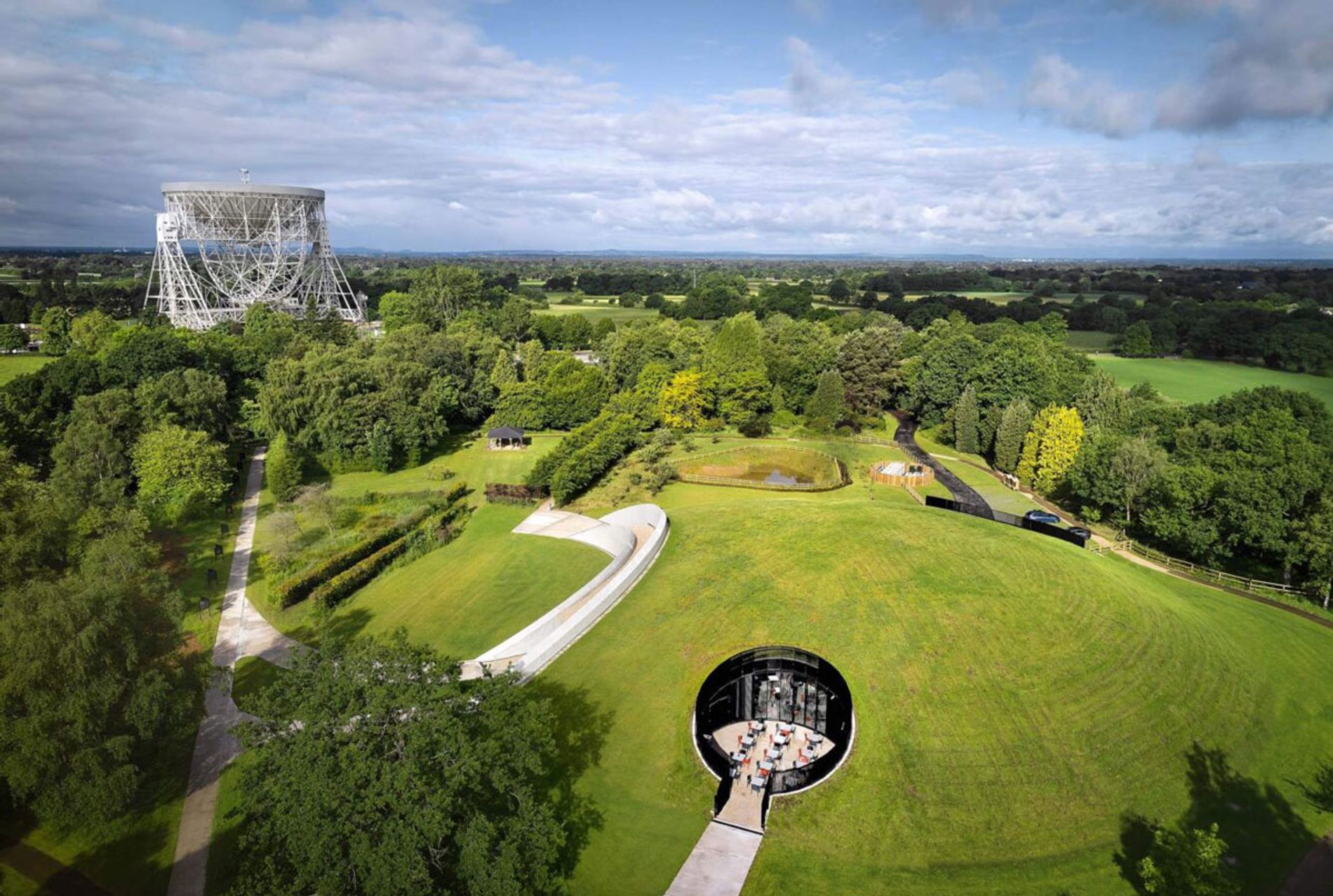 Images shows an aerial shot of Jodrell Bank's Lovell Telescope and the First Light Pavilion. Soundscape and soundtracks by Coda to Coda