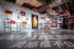 Image shows the Nike Yo Hood space in Shanghai Expo, with a large audio visual panel in the middle of the room, with an animation of feet, with sound design by Coda to Coda