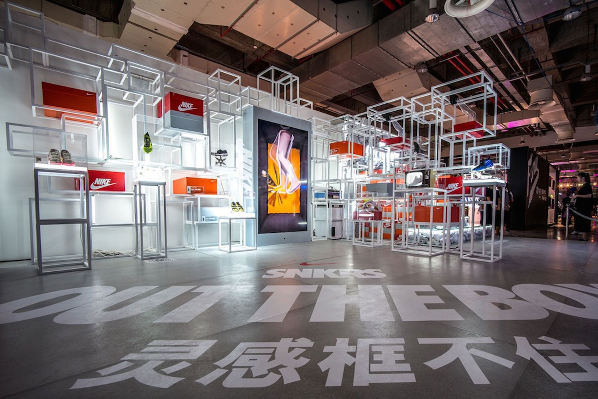 Image shows the Nike Yo Hood space in Shanghai Expo, with a large audio visual panel in the middle of the room, with an animation of feet, with sound design by Coda to Coda
