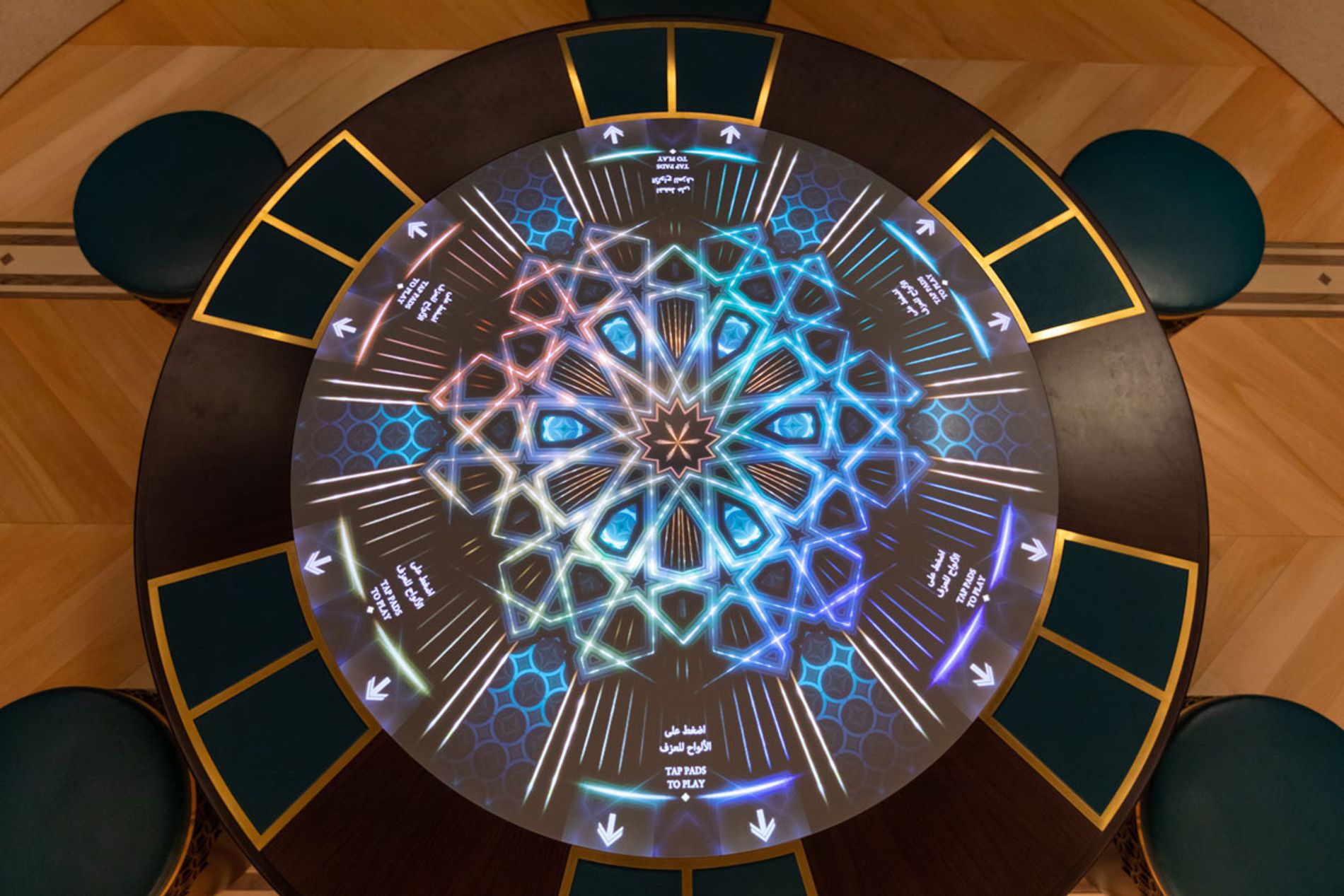 Image shows an overhead view of the Drumming interactive table at Oman and the World: A Musical Journey in Muscat. Installation composer: Coda to Coda