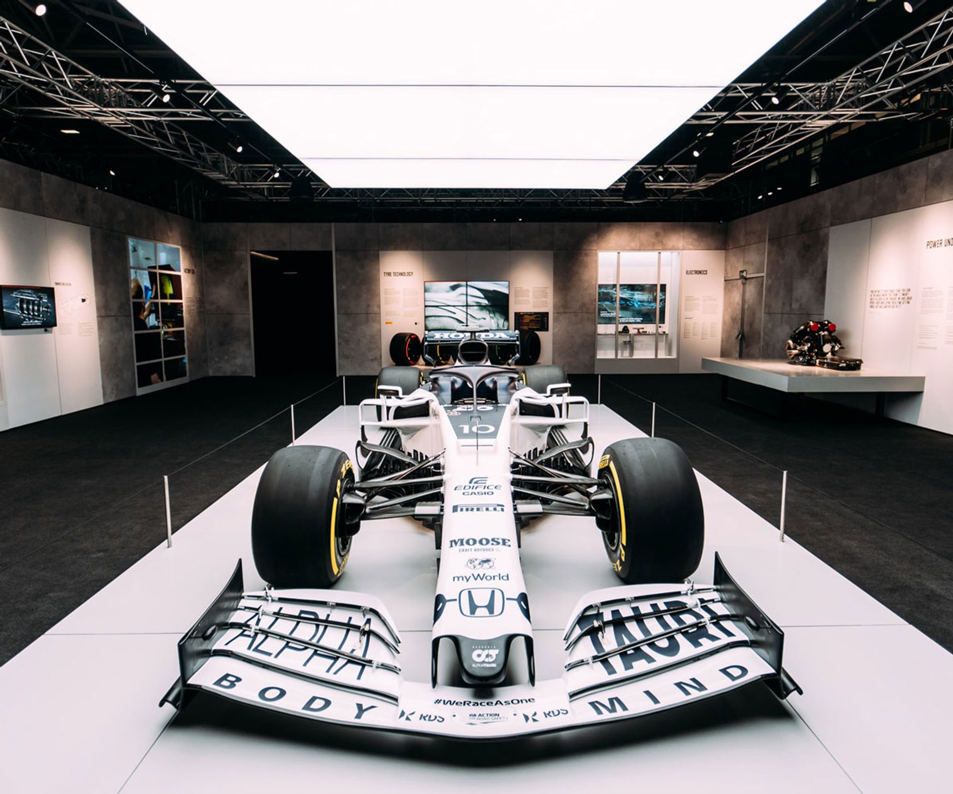 A white Formula 1 car on a raised platform at Formula 1 Exhibition. Soundscape by Coda to Coda