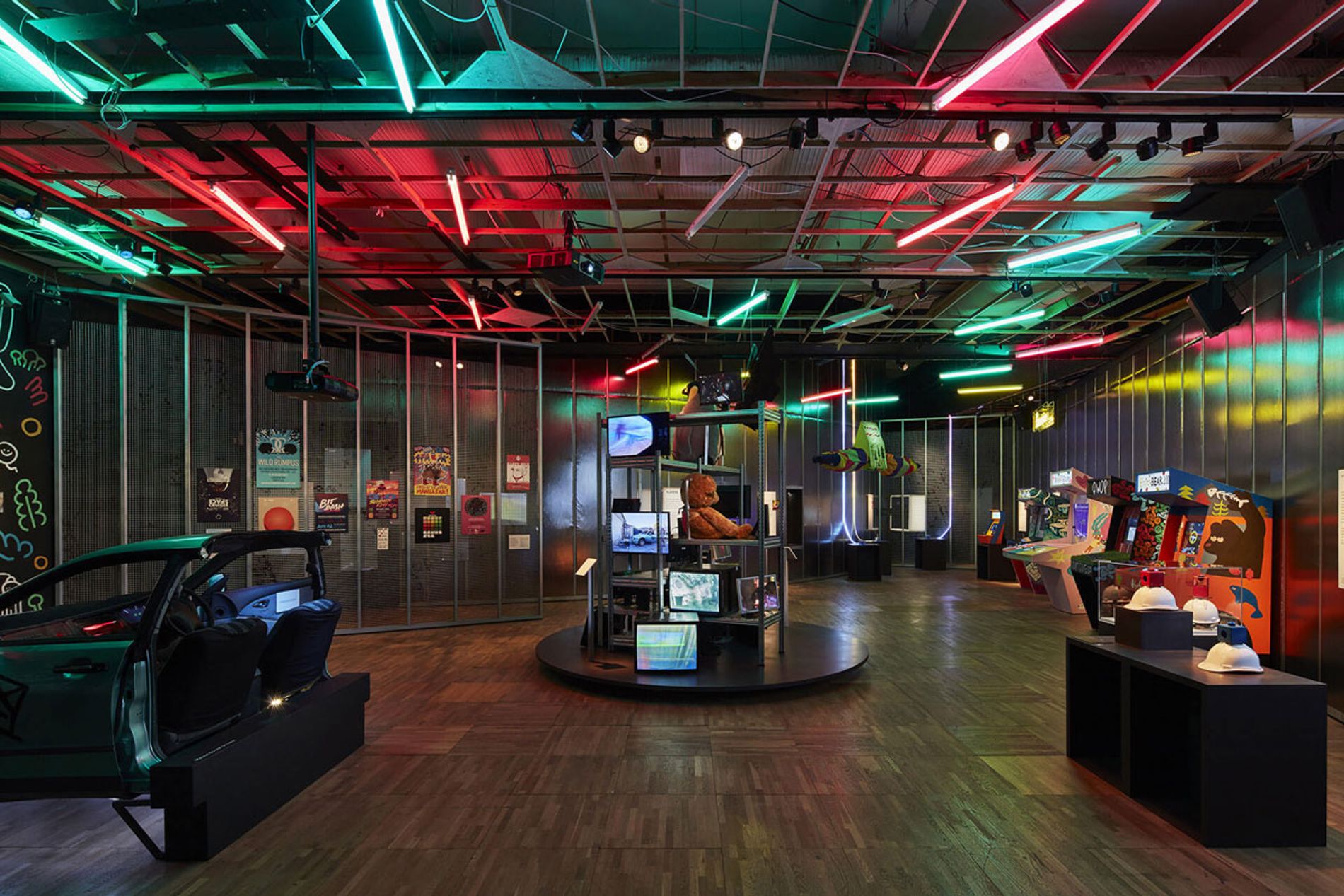 Image shows several arcade games in the DIY Cultures section of Videogames: Design/Play/Disrupt at the V&A London. Exhibition soundscape by Coda to Coda