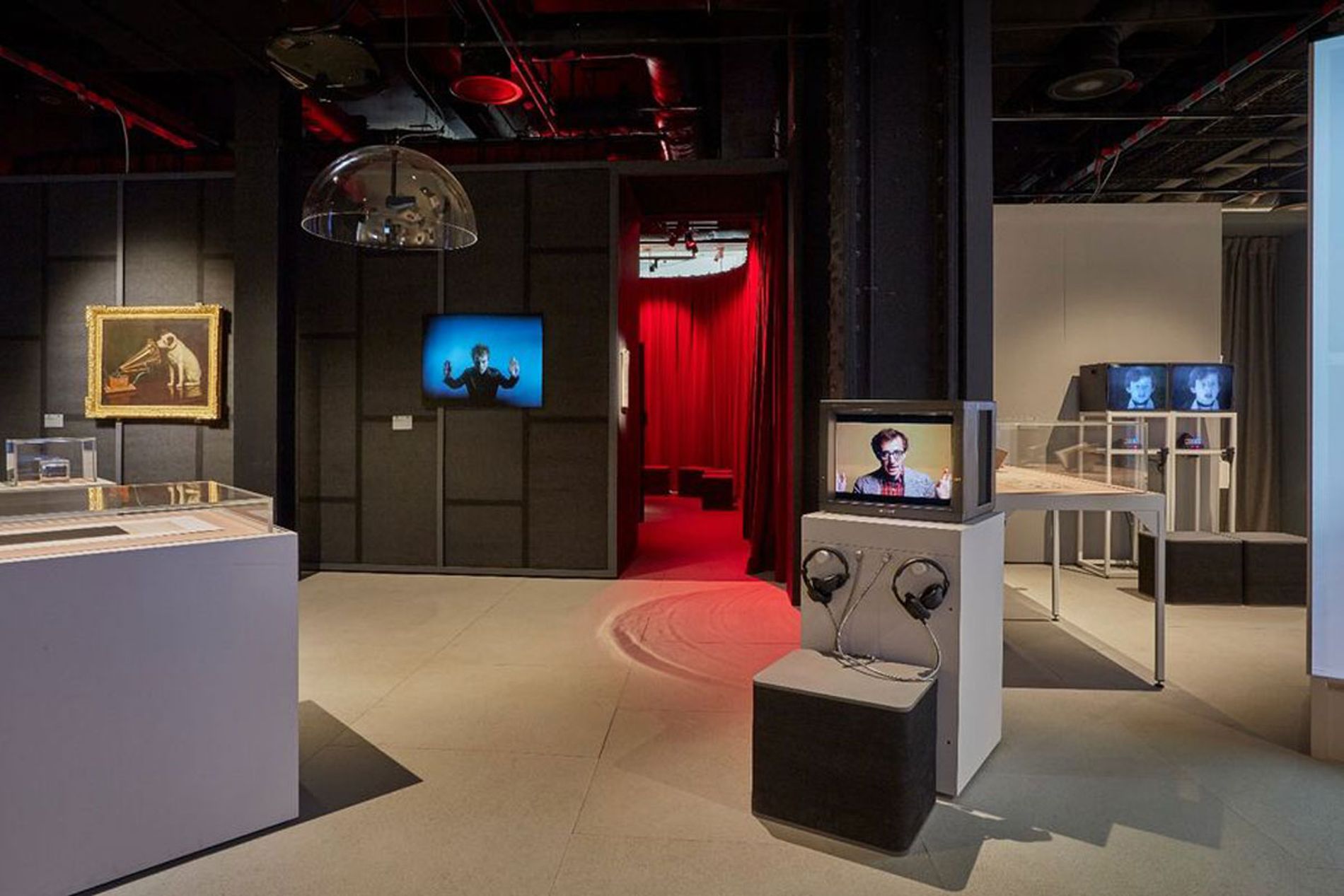 Image showing the galleries and the exterior of the installation, which is surrounded by red velvet curtains, with soundscape by Coda to Coda