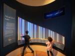 Image shows two children playing the interactive about Scales at Oman and the World: A Musical Journey in Muscat. Installation composer: Coda to Coda