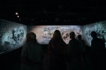 Visitors look at an audiovisual installatio depicting the timeline of Carl Nielsen's life in the Calibration section at the Carl Nielsen Museet. Sound by Coda to Coda