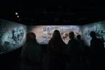 Visitors look at an audiovisual installatio depicting the timeline of Carl Nielsen's life in the Calibration section at the Carl Nielsen Museet. Sound by Coda to Coda