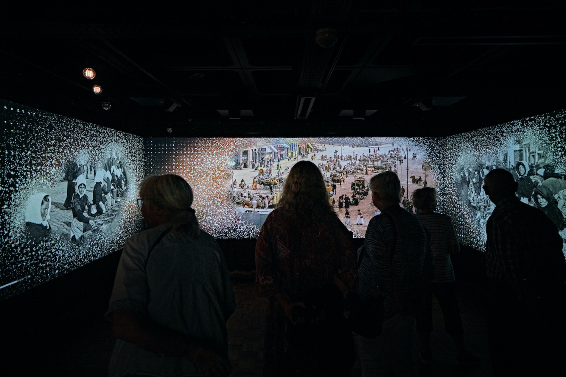 Visitors look at an audiovisual installatio depicting the timeline of Carl Nielsen's life in the Calibration section at the Carl Nielsen Museet. Sound by Coda to Coda
