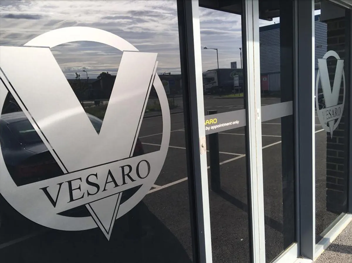 Vesaro V logo etched on the glass frontage of the showroom entrance