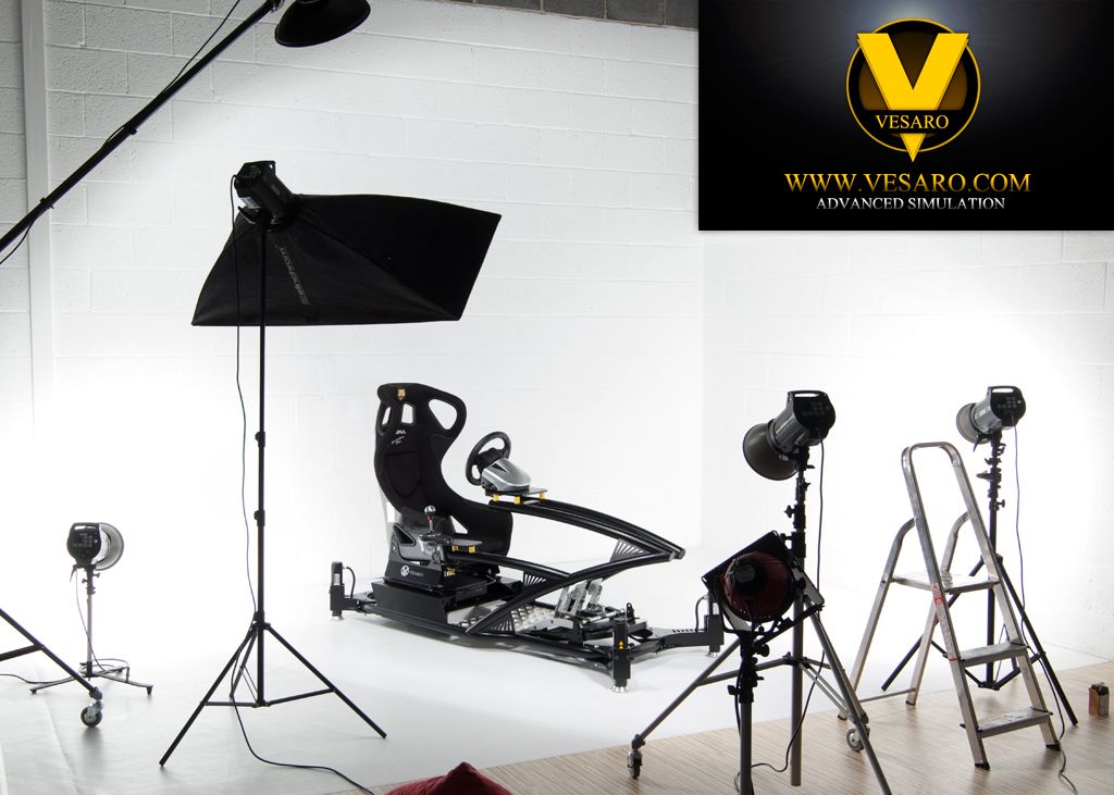 Vesaro racing simulator in a white photo studio surrounded by softbox lights and a stepladder