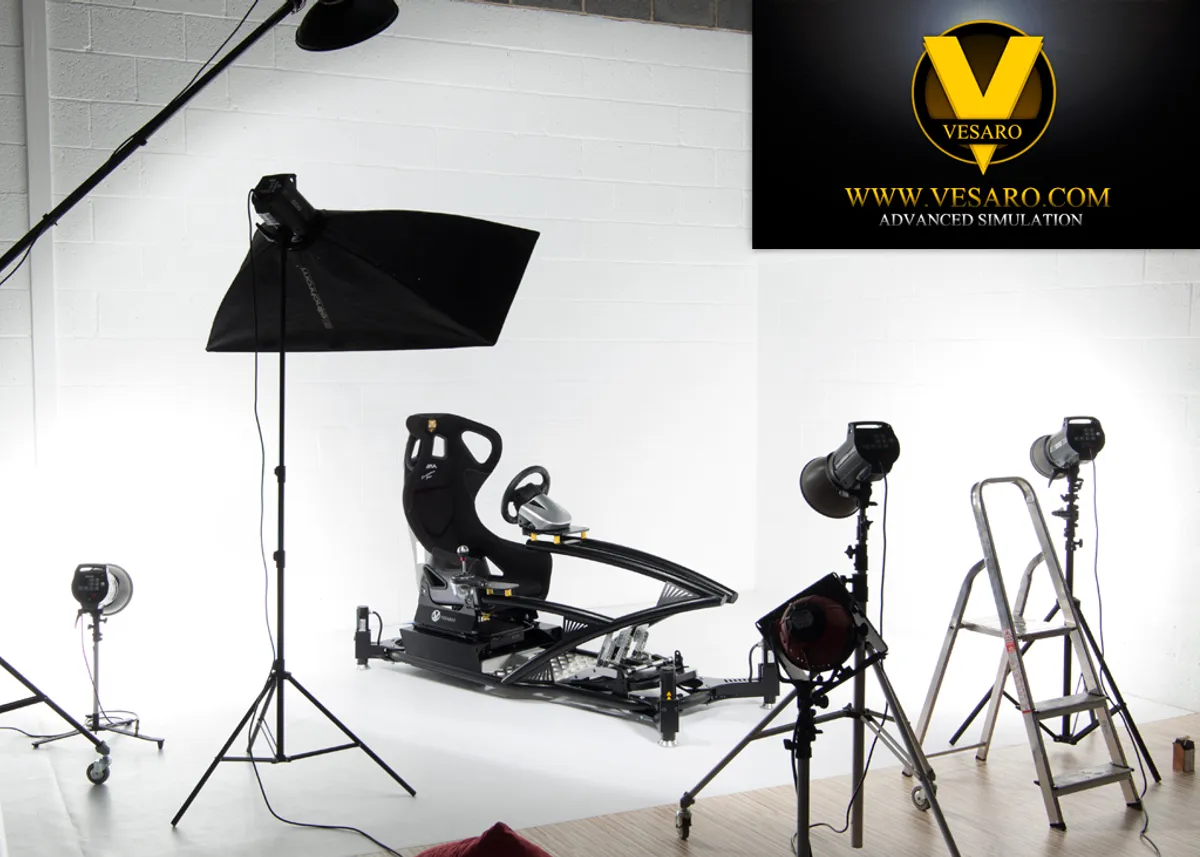 Vesaro racing simulator in a white photo studio surrounded by softbox lights and a stepladder