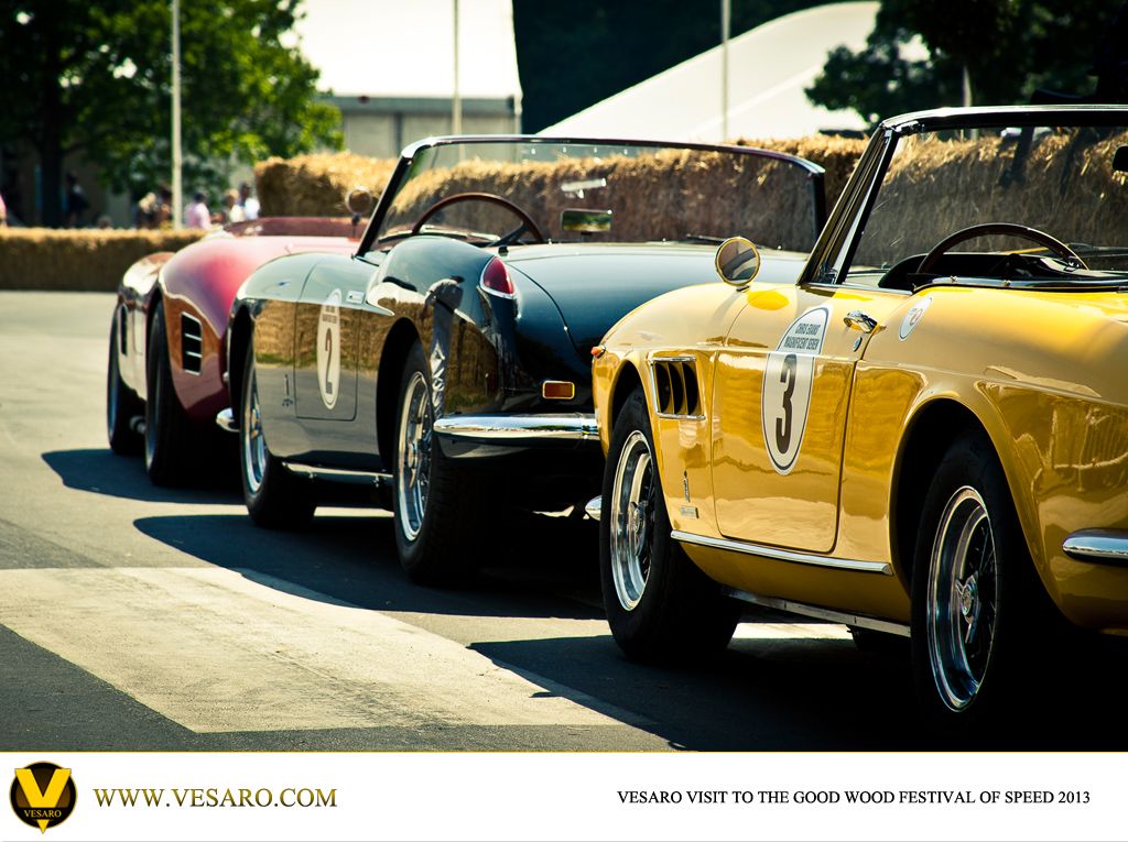 Line of classic Ferrari sports cars in yellow, black and red waiting at Goodwood Festival of Speed 2013