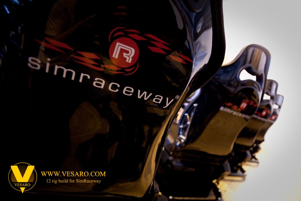 Black racing bucket seats branded Simraceway lined up in a row, close-up with shallow focus