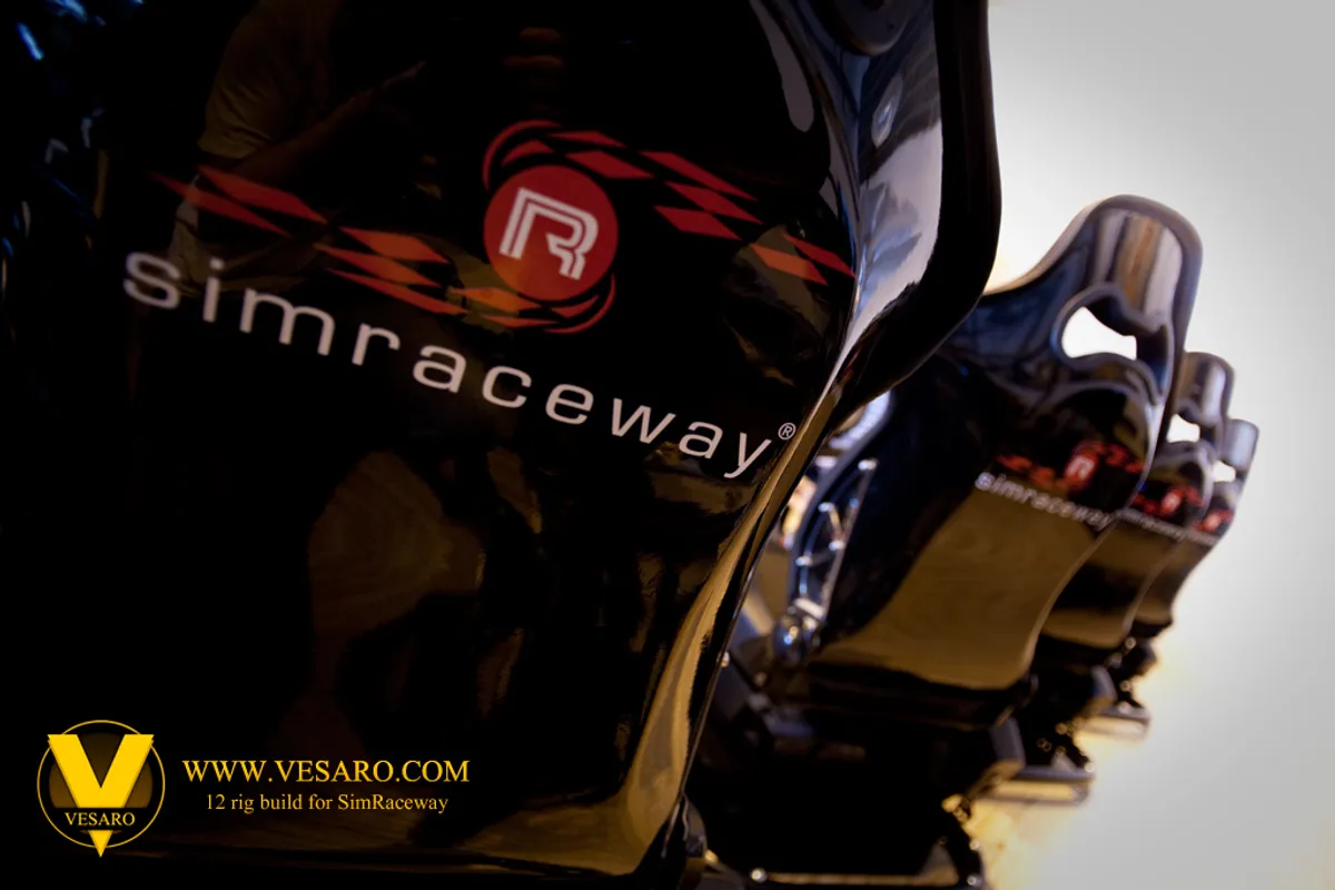 Black racing bucket seats branded Simraceway lined up in a row, close-up with shallow focus