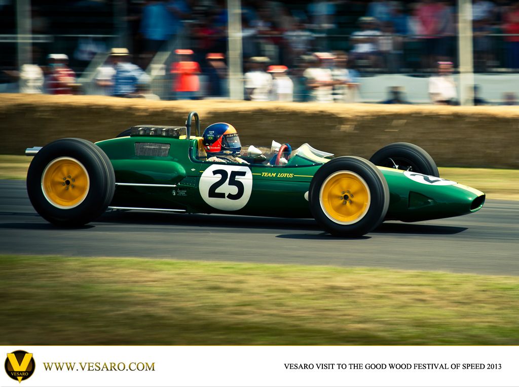 Green Lotus grand prix car number 25 with yellow wheels racing at Goodwood Festival of Speed 2013