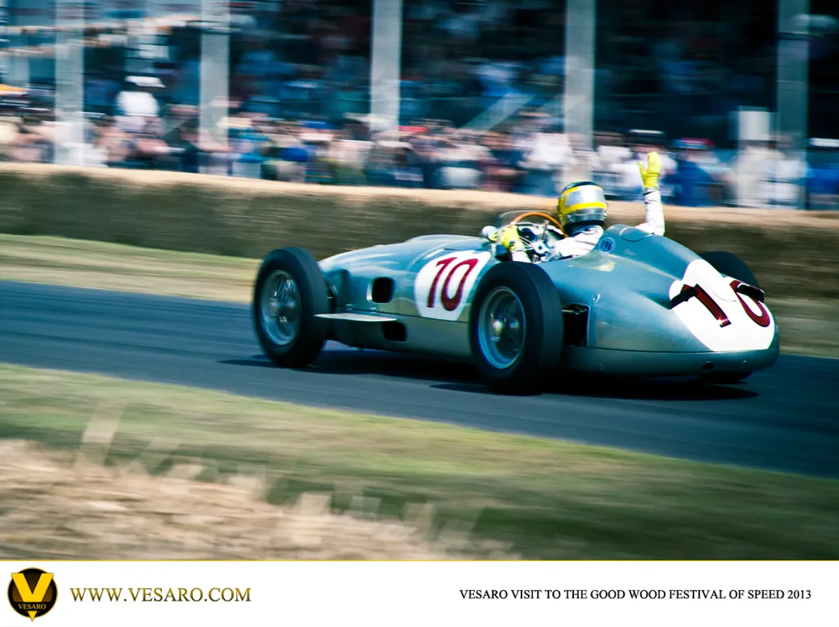 Silver vintage Mercedes grand prix car number 10 driven up the hill at Goodwood Festival of Speed 2013