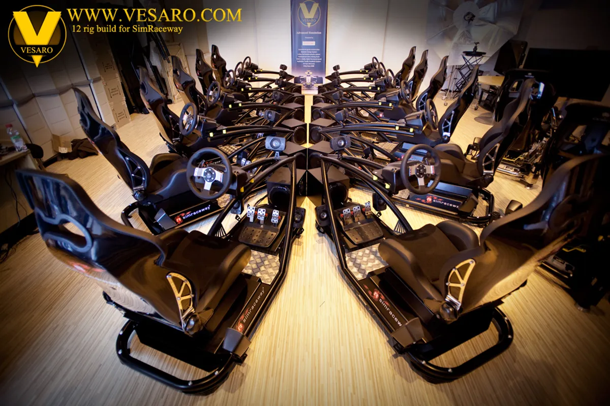 Overhead view of twelve black Vesaro racing simulator rigs arranged in a circle around a central pillar