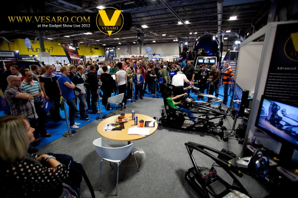 Busy exhibition hall with a crowd watching Vesaro simulators at Gadget Show Live 2012