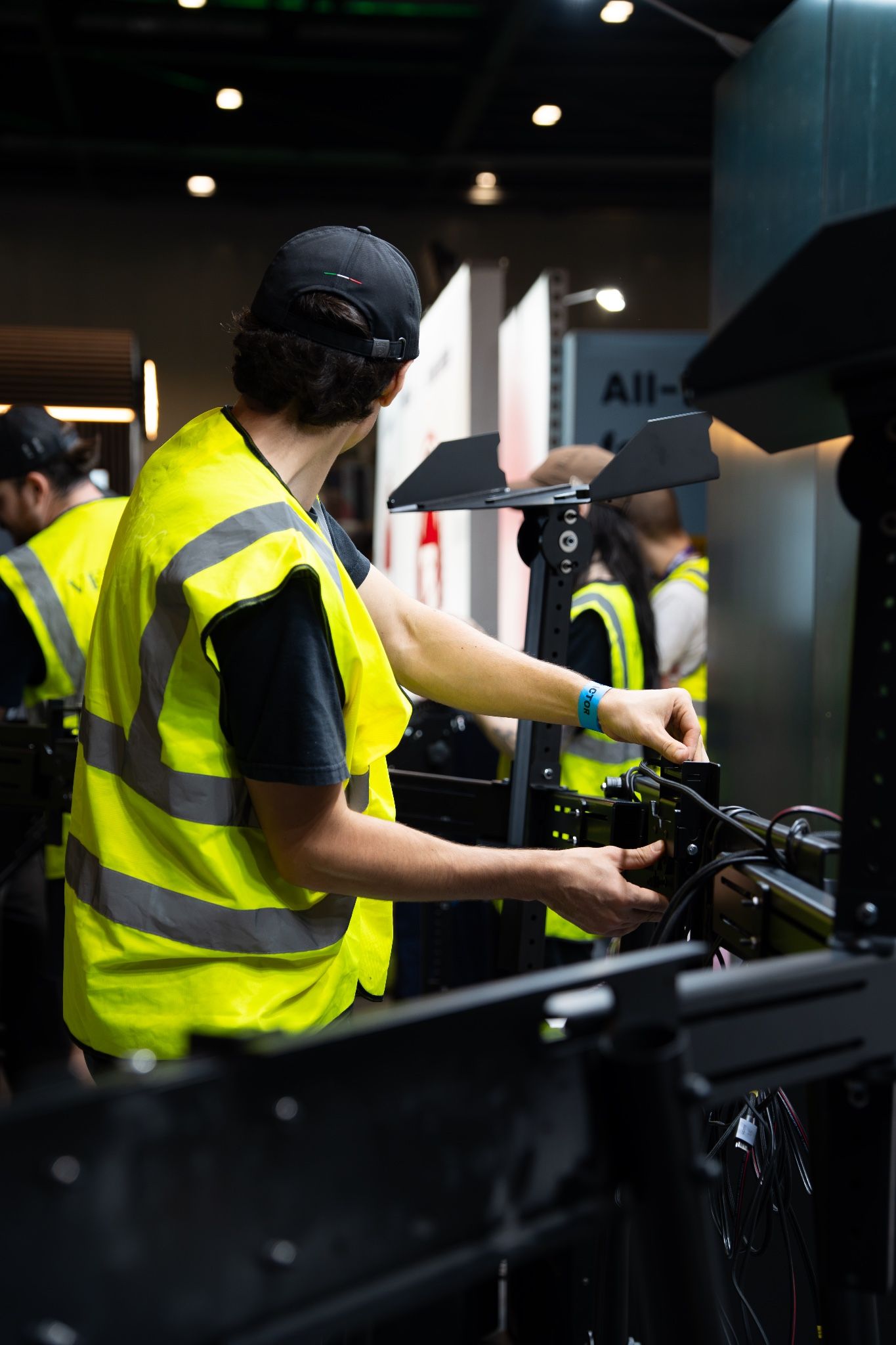 Vesaro team member in hi-vis setting up a display during the stand build at ExCeL London