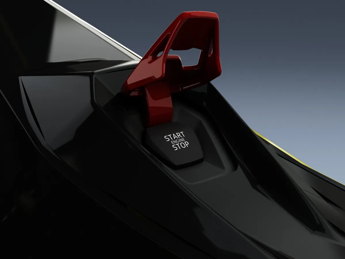 Close-up of the red start-stop engine button and guard on a black and yellow Lamborghini-styled simulator