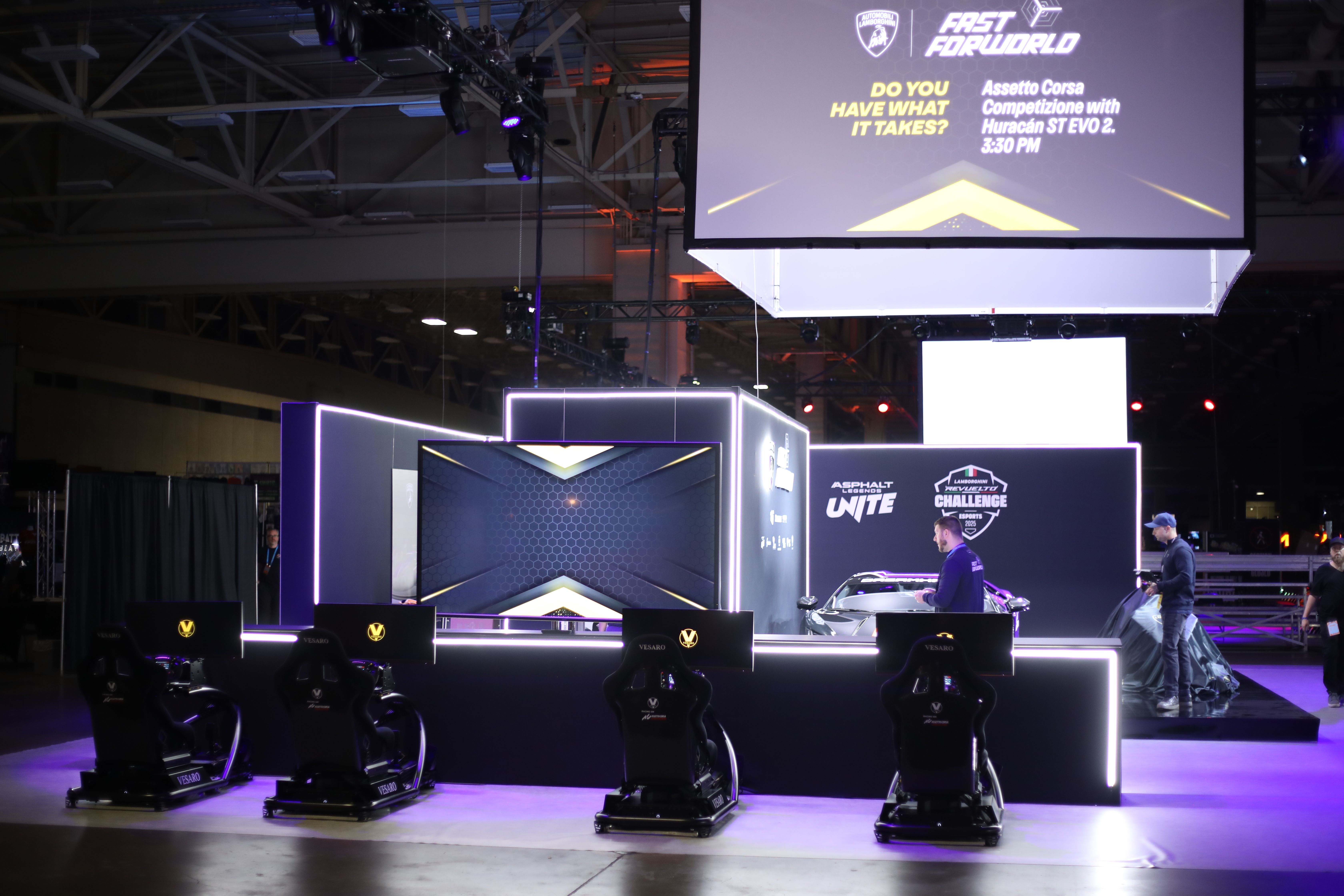 Lamborghini-branded stage with a large screen and three Vesaro rigs in front under purple lighting in a big hall