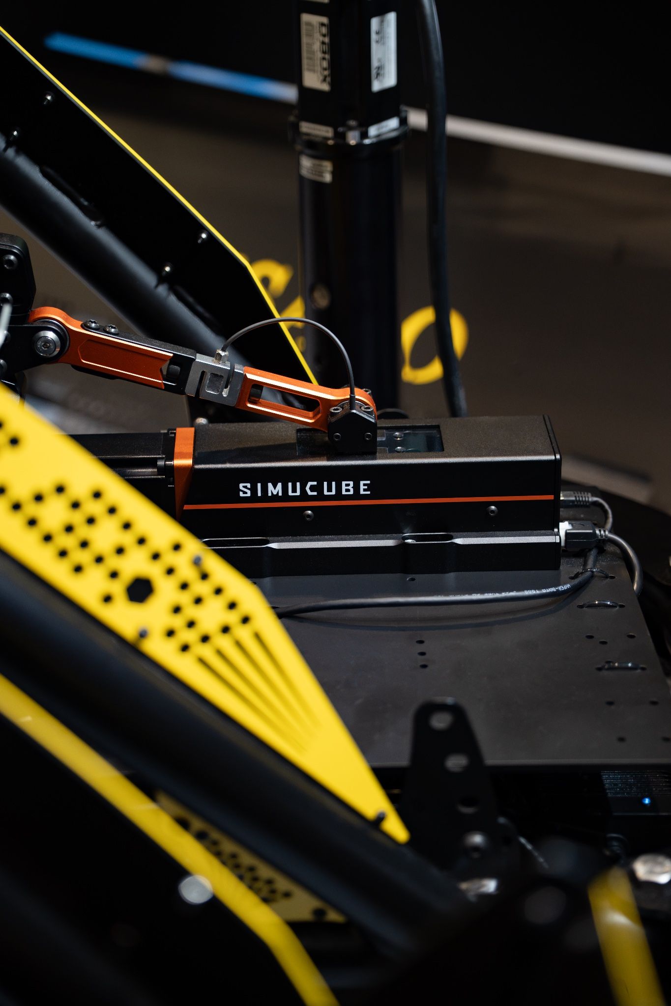 Close-up of a Simucube wheelbase in a Vesaro simulator