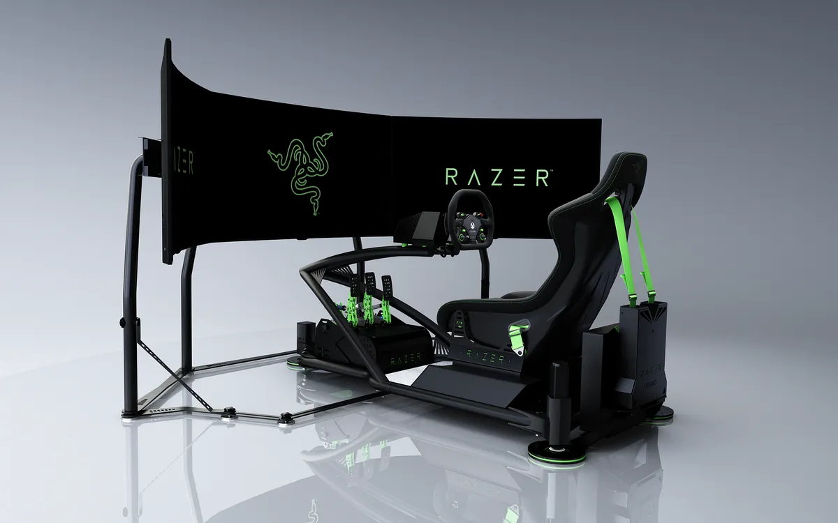 Razer-branded racing simulator with a wide curved display, green harness and motion base