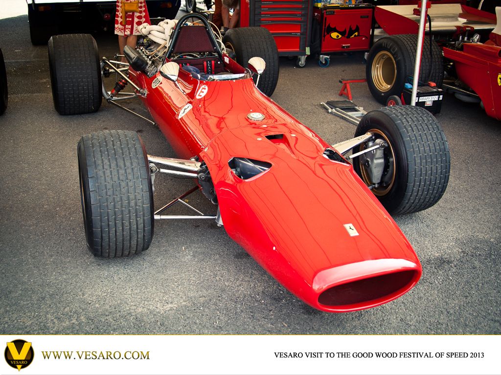 Vintage red Ferrari Formula 1 car parked in the paddock at Goodwood Festival of Speed 2013