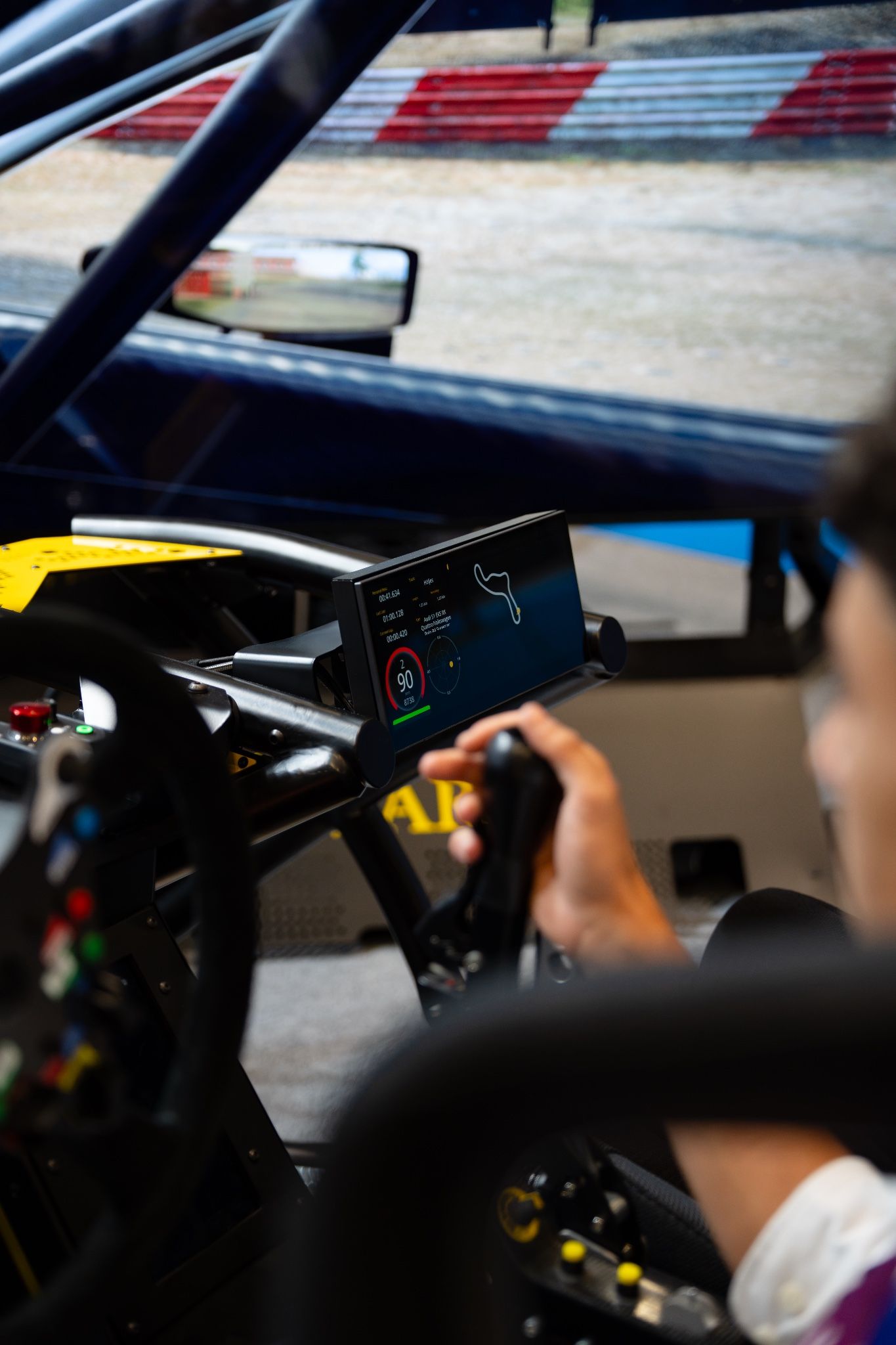 Driver's view of the Vesaro Rally's digital dashboard and sequential shifter
