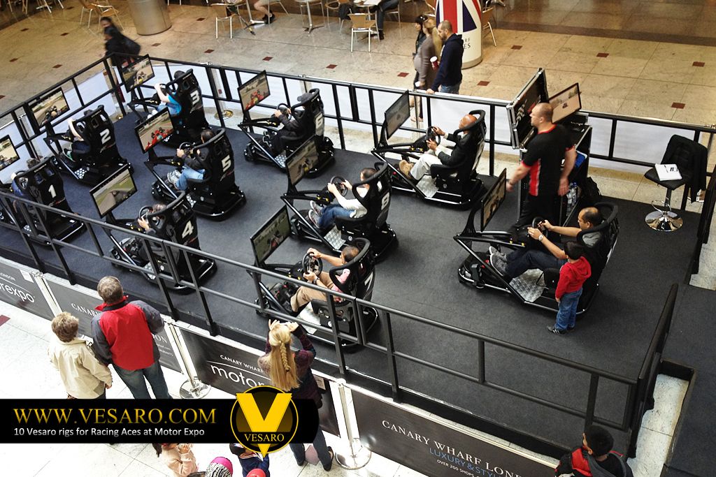 Elevated view of several drivers seated on Vesaro simulators with monitors in a Canary Wharf shopping centre