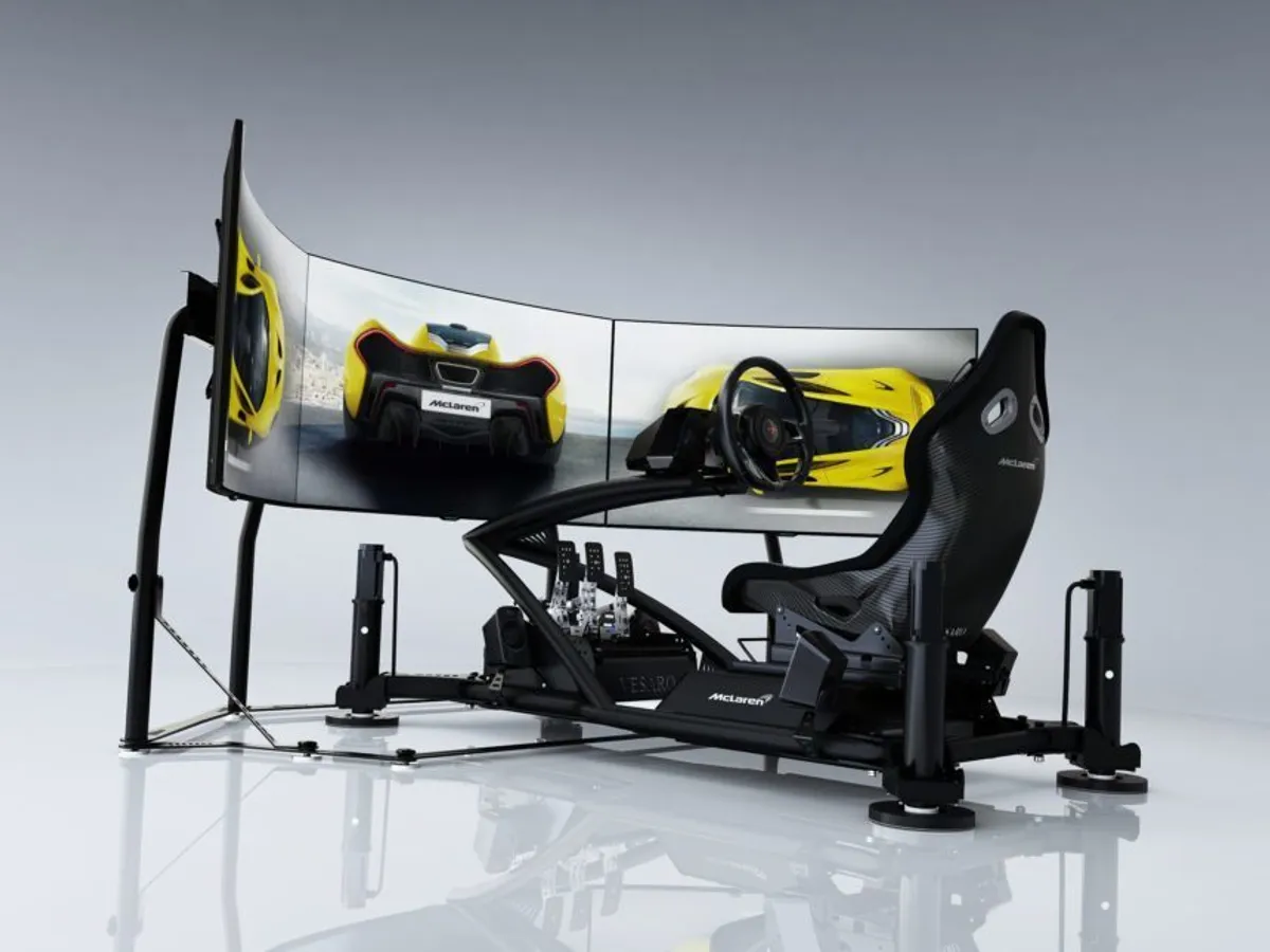McLaren-branded simulator with triple curved displays showing a yellow McLaren P1 and motion actuators