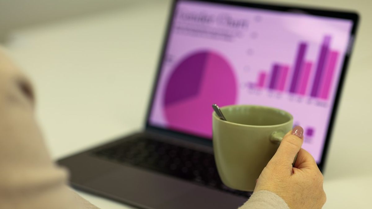 Person working on a laptop with a cup of coffee