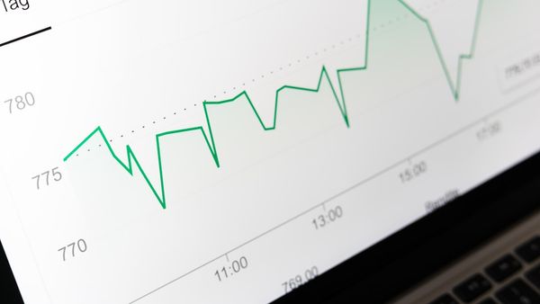 stock market chart displayed on laptop screen