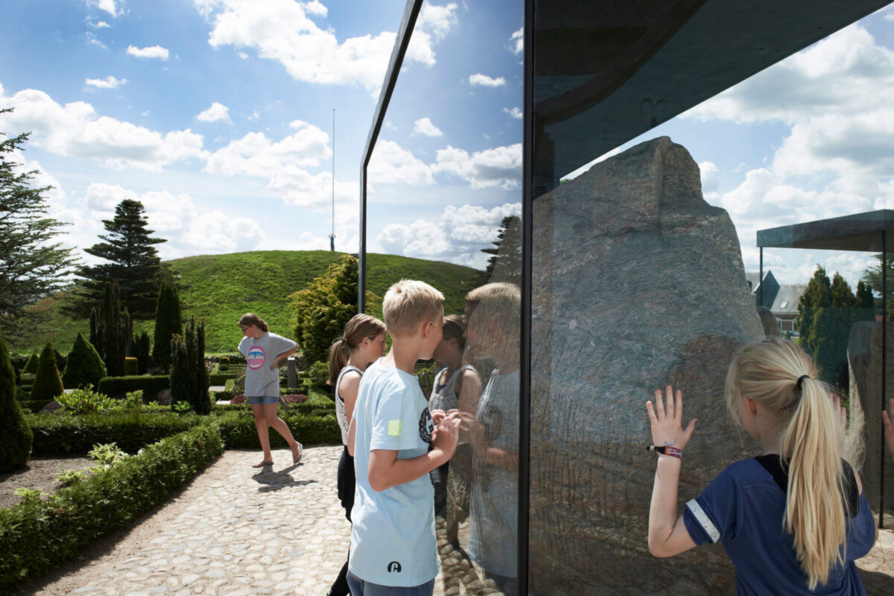 Children looking at the large Jelling Stone