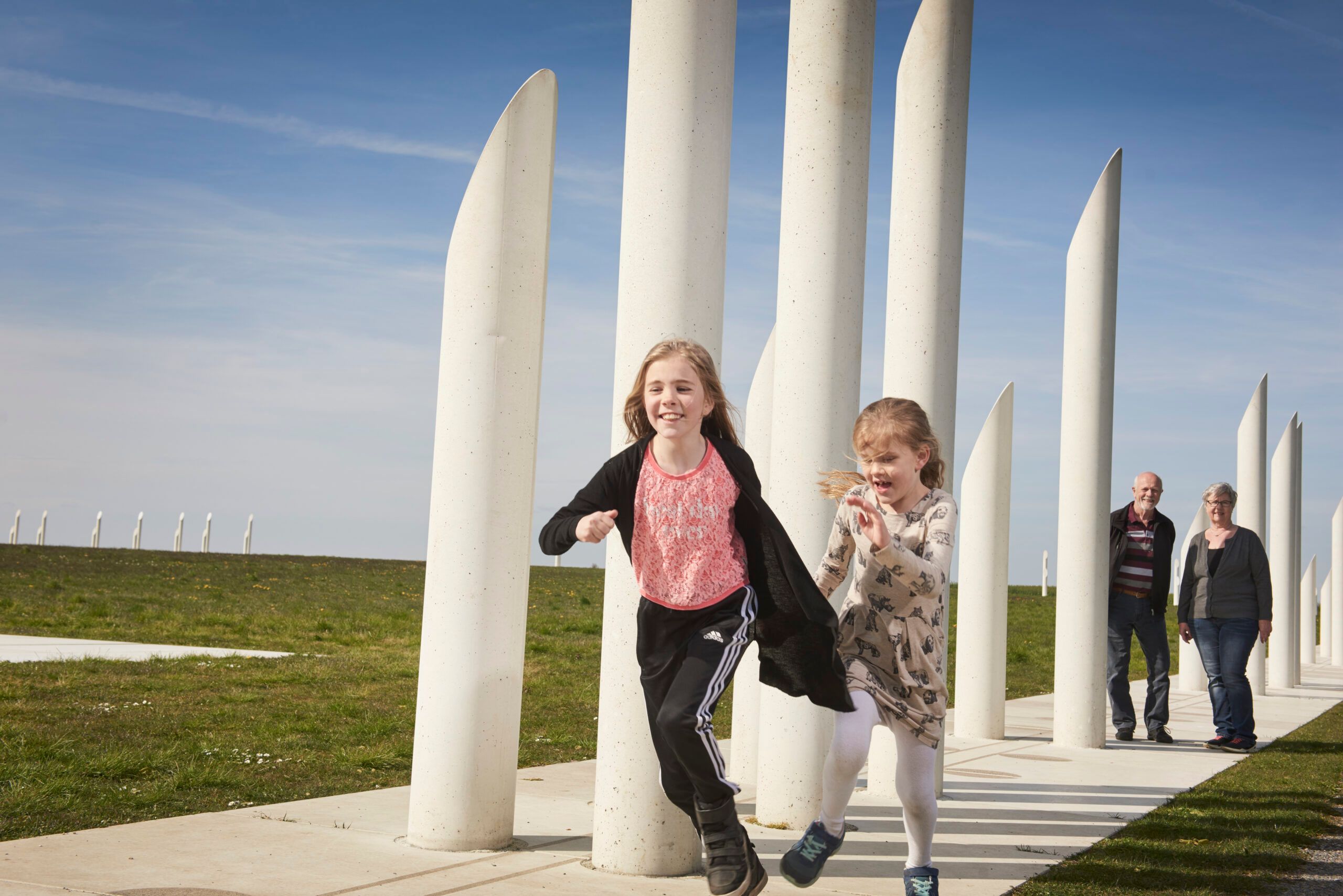 Girls running in front of the palisade