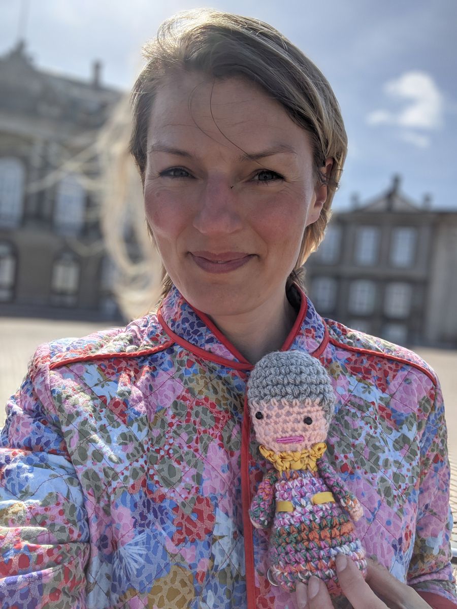 Christine Sørensen holding a crotched miniature of Margrethe II
