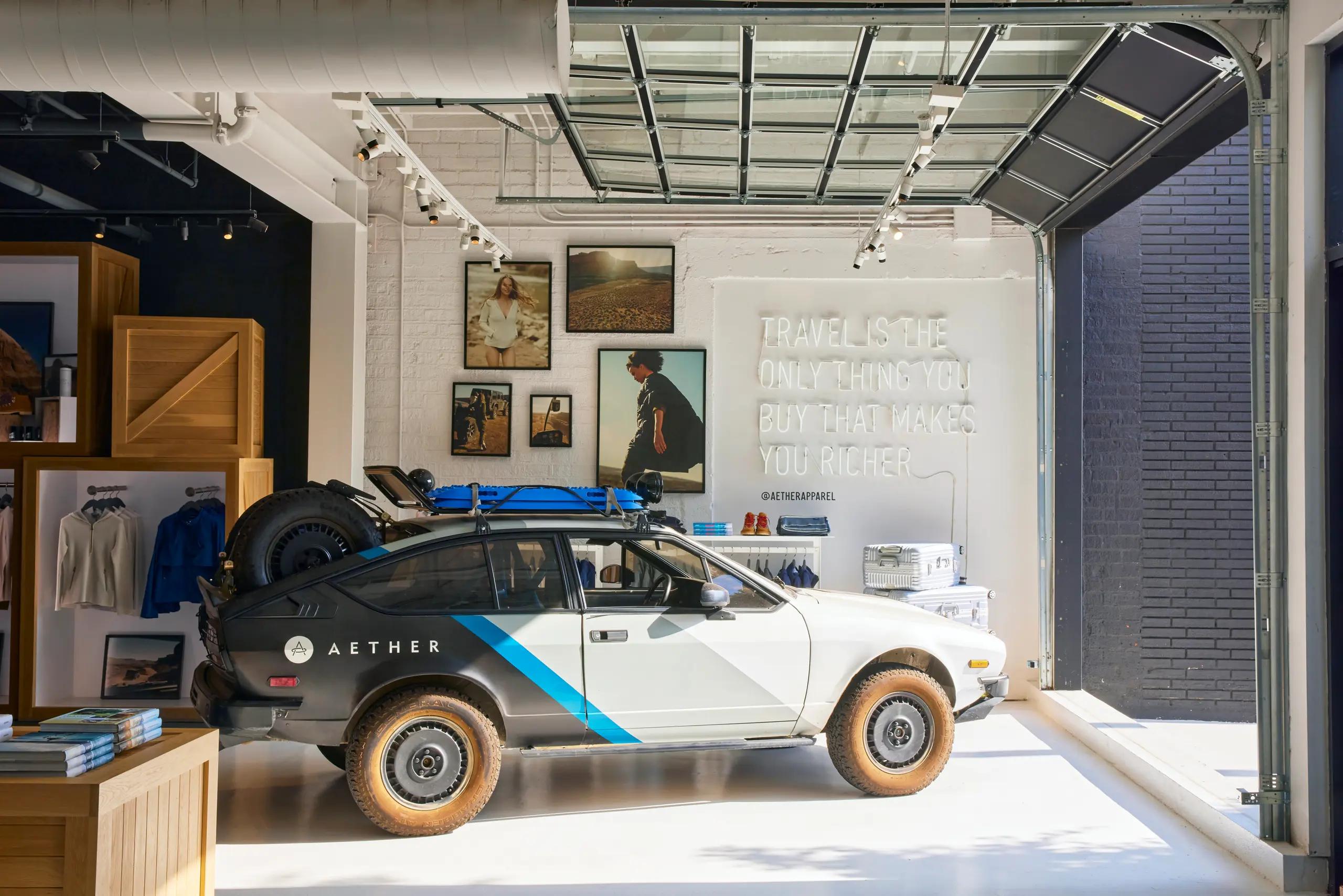 A parked car is visible inside an Aether Apparel store, framed by a large window showcasing the interior space.