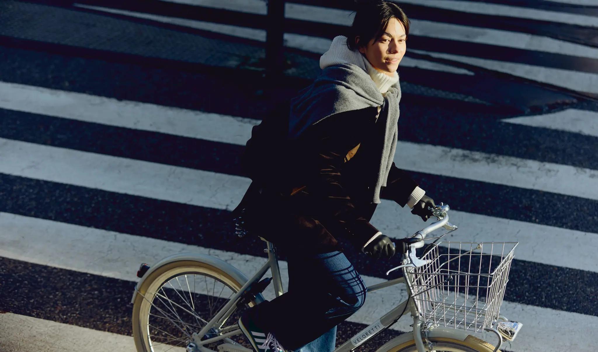 young woman riding a bike on a street