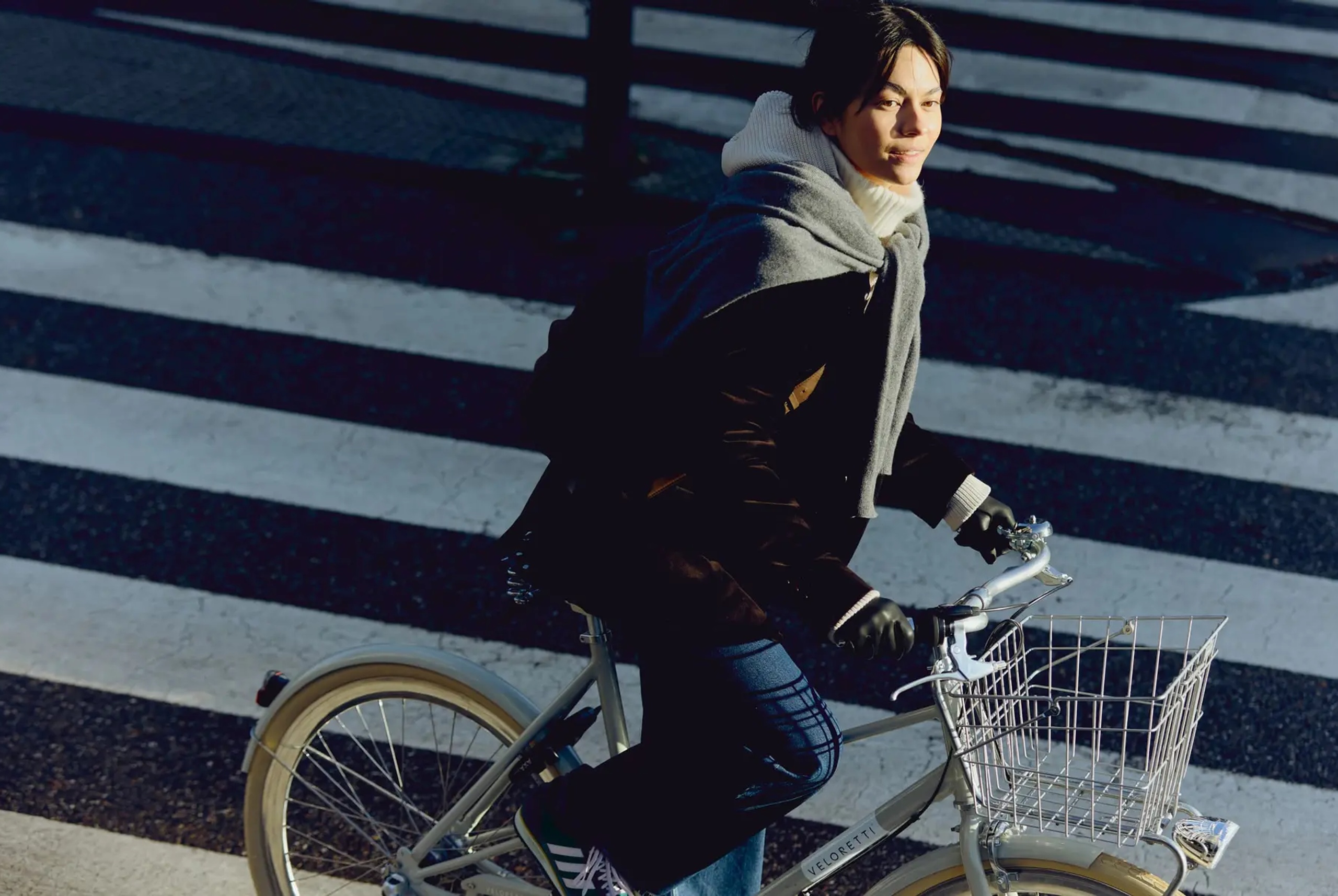 young woman riding a bike on a street