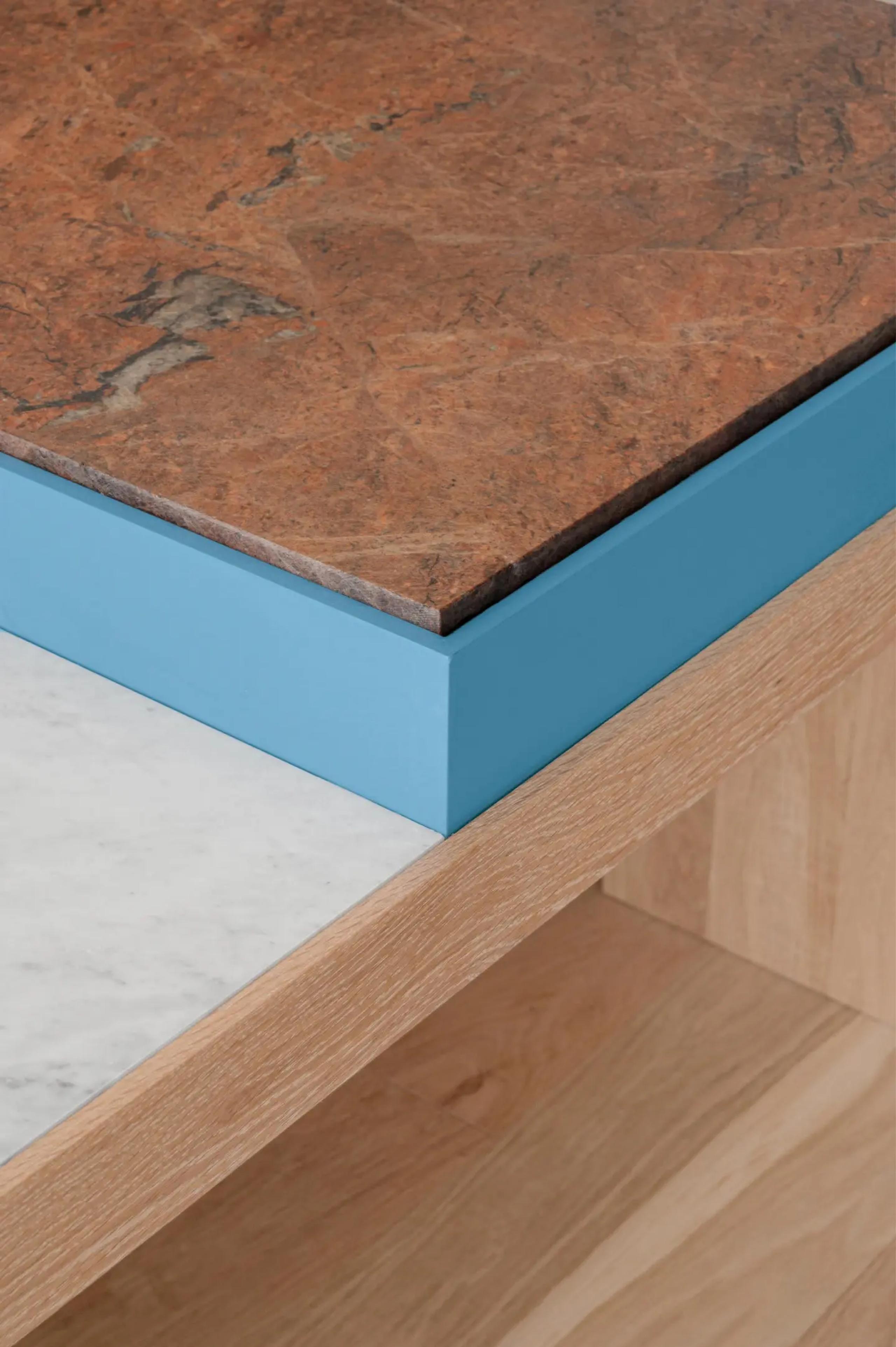 A marble table with striking blue trim and a wooden frame, exemplifying a harmonious fusion of materials and design.