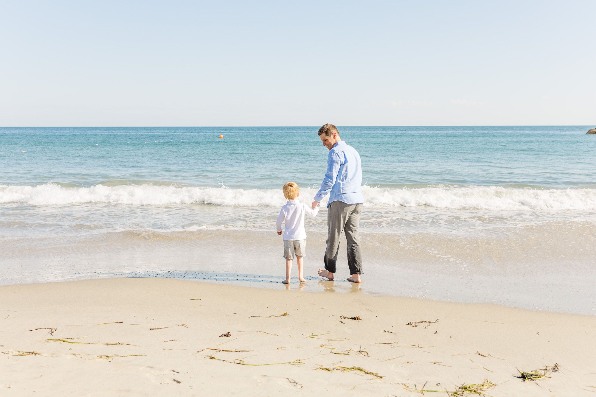 Father and son walking on elephant rock in Westport, MA