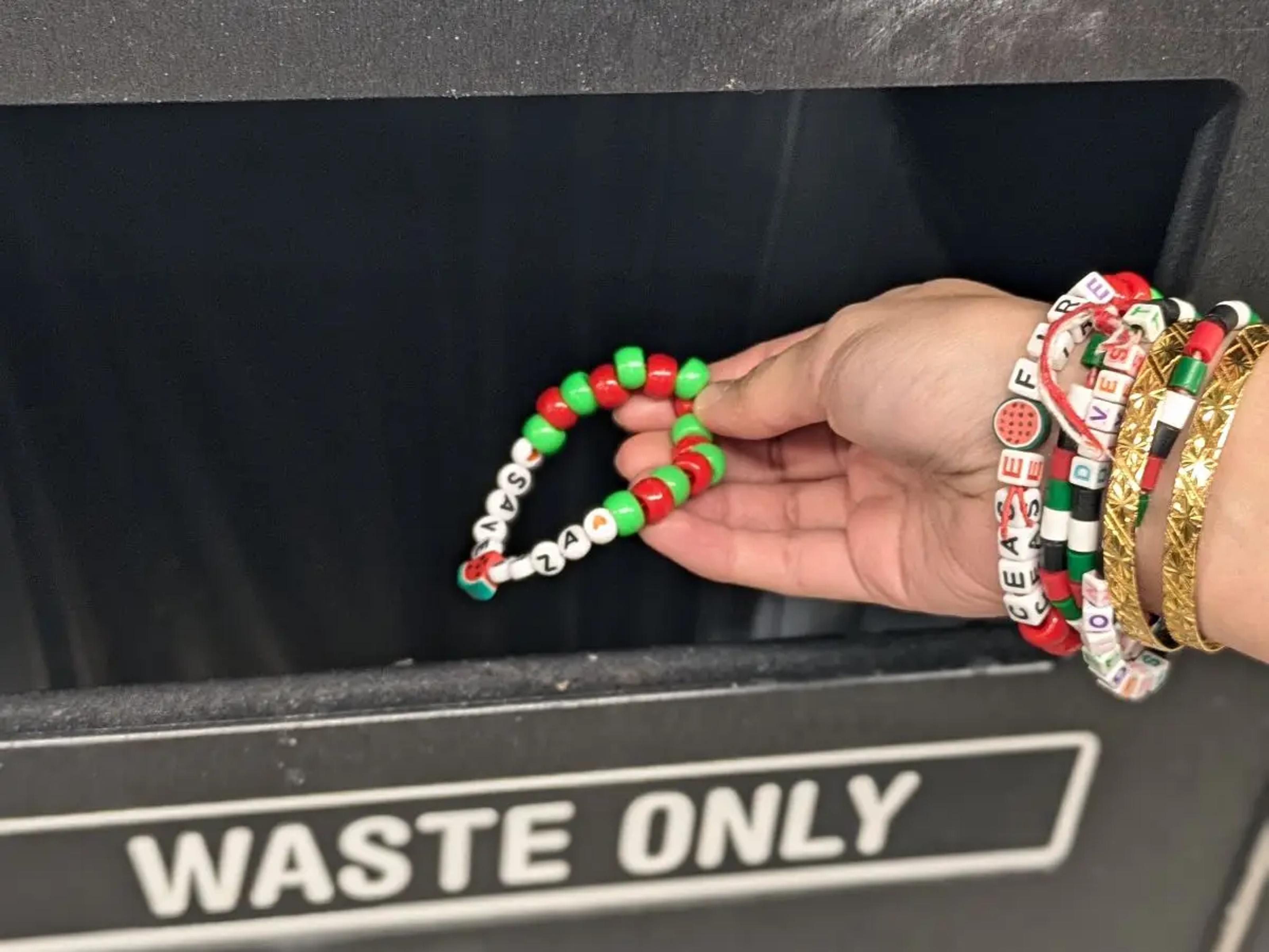 A 'free gaza' bracelet being thrown away