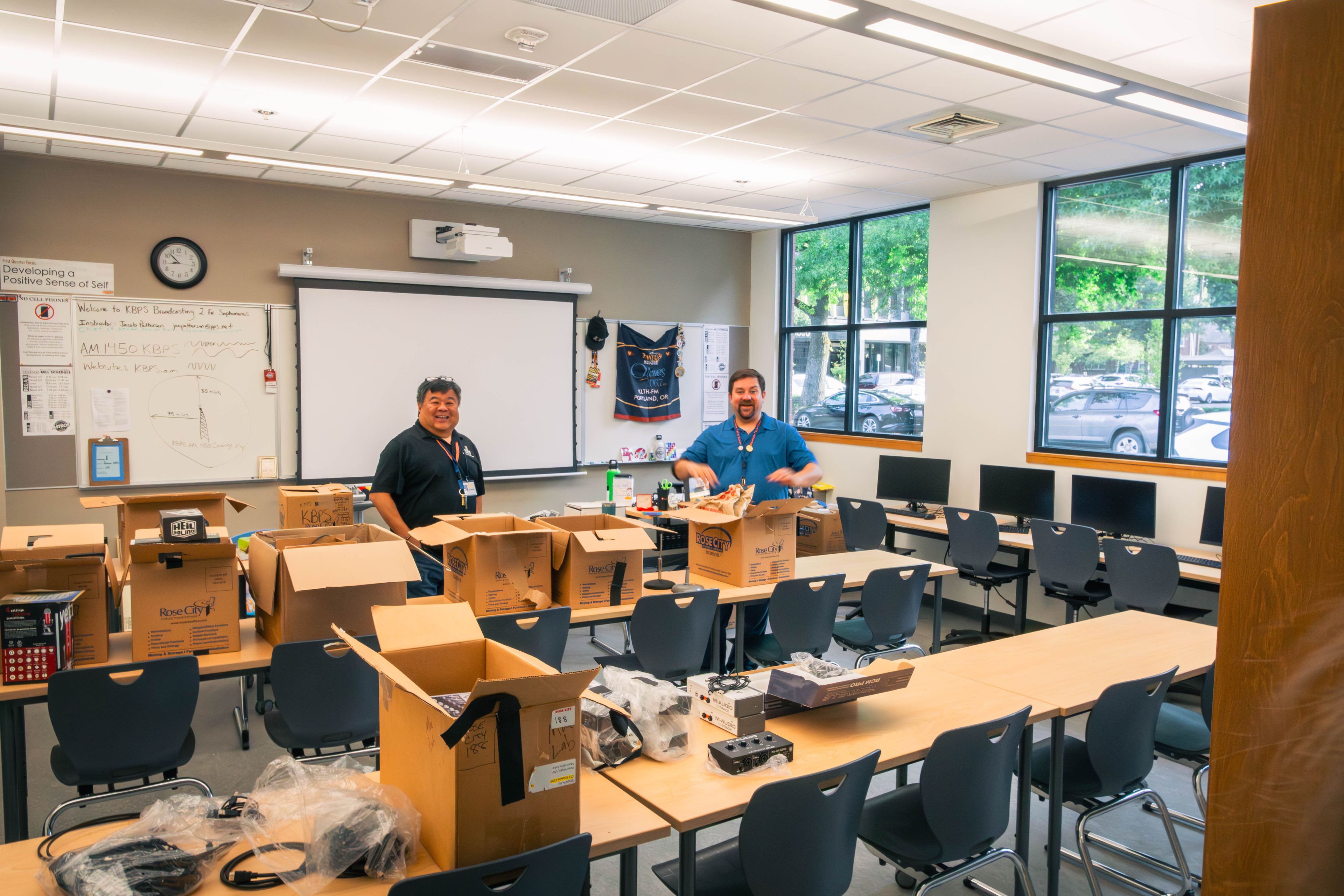 Boxes being unpacked in a Benson radio classroom