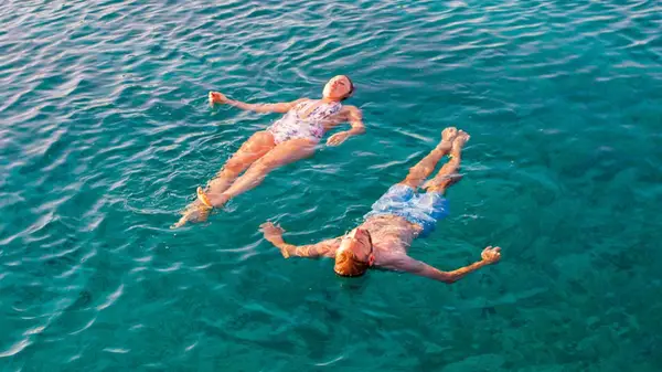 Two people floating in the Mediterranean 